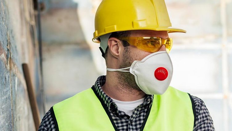 Front view worker with protective mask hard hat