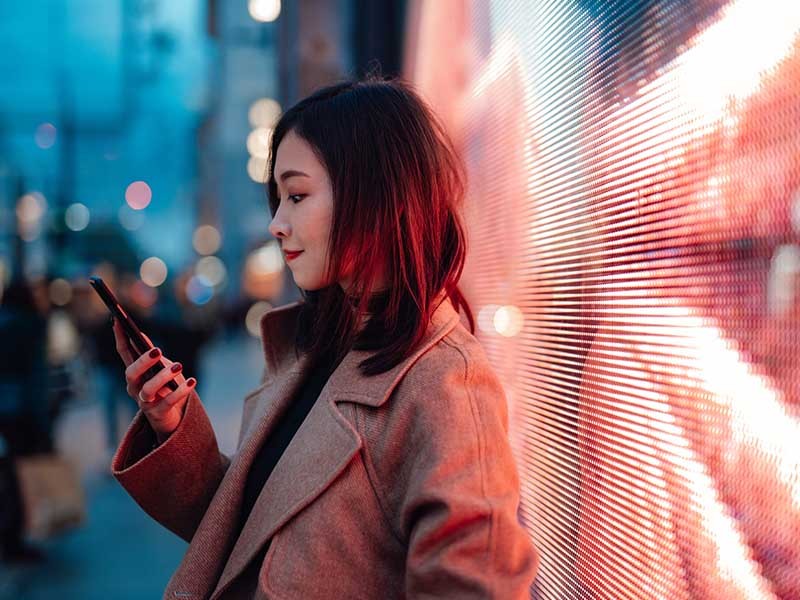 Women standing and seeing her phone