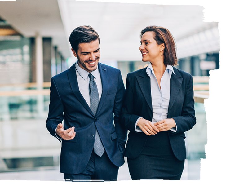 Two working professionals smiling while talking about something