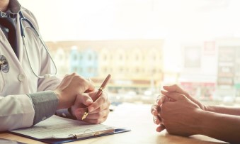 A doctor prescribing something to the patient