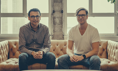 Mihir Shah and Yishai Lerner sitting on sofa