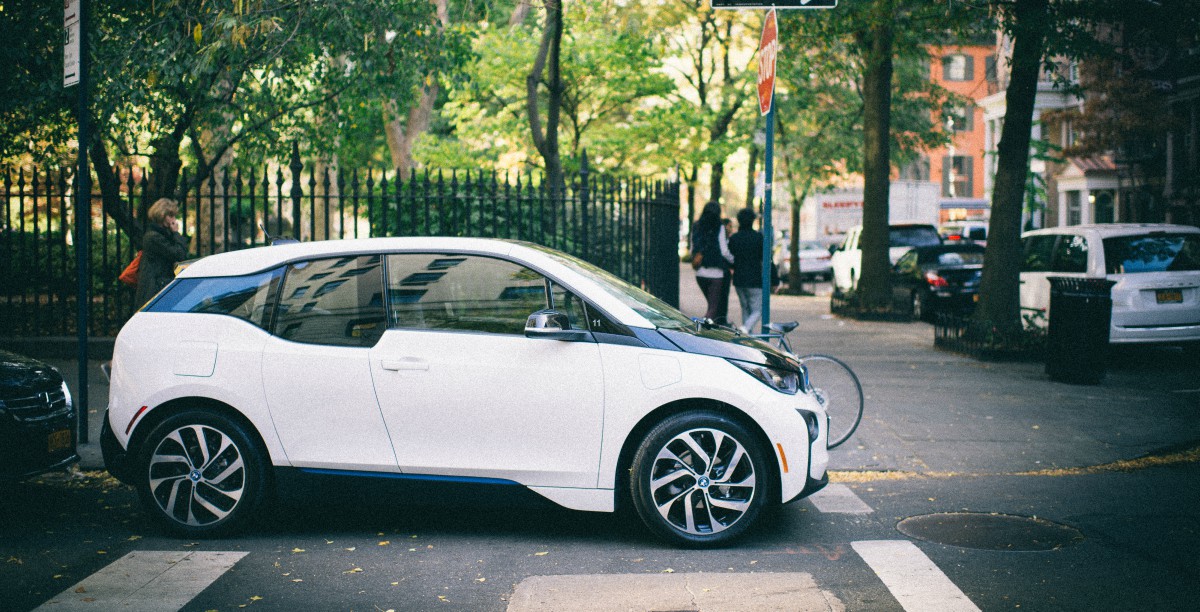 white electric car at stop sign