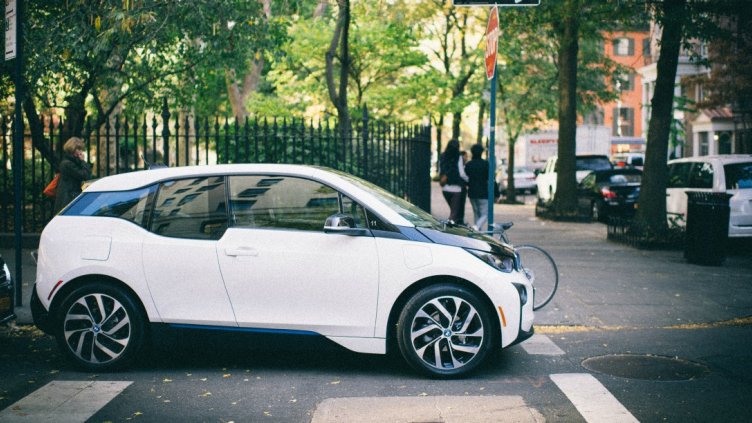 white electric car at stop sign