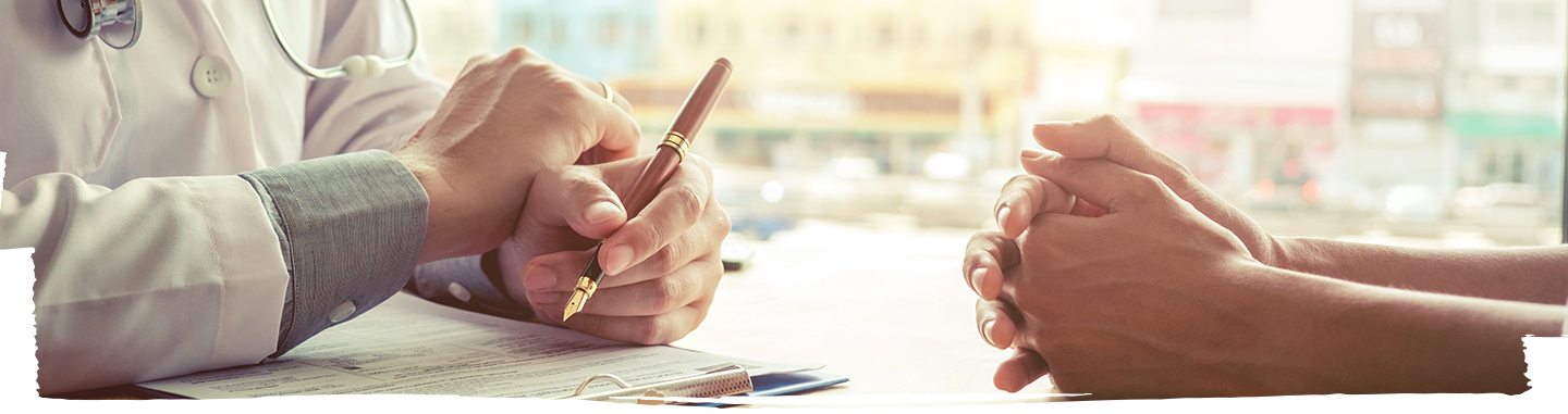 Doctor writing prescription to patient