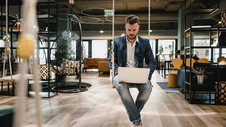 Man in office on swing