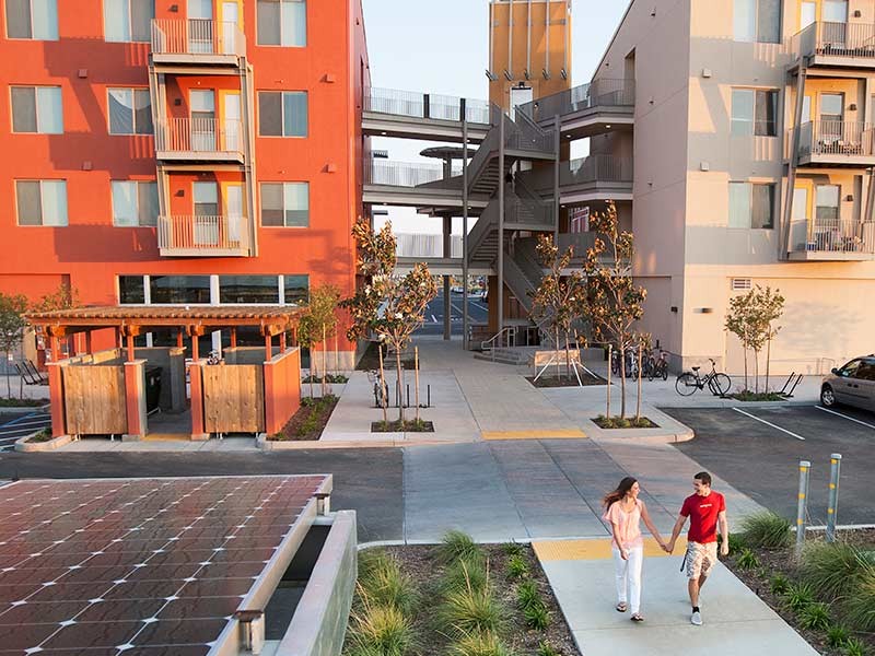 Couple walking in ground outside the beautiful buildings