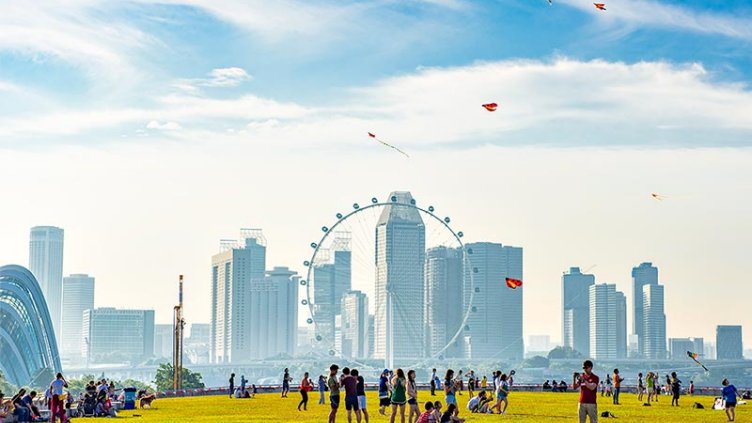 Group of people enjoying in the open area beside real estate office buildings