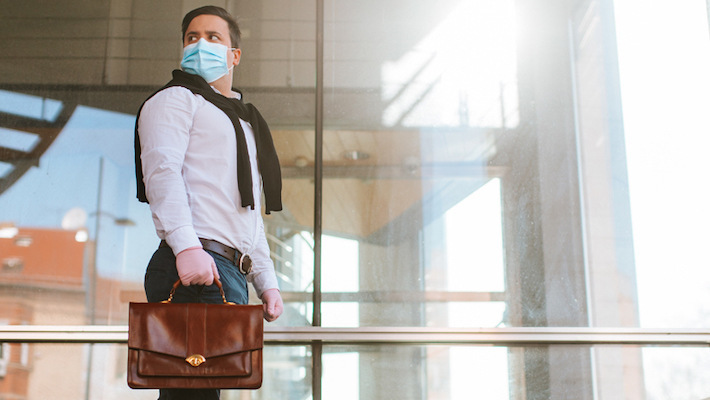 Picture of an employee return to workplace having mask and gloves on