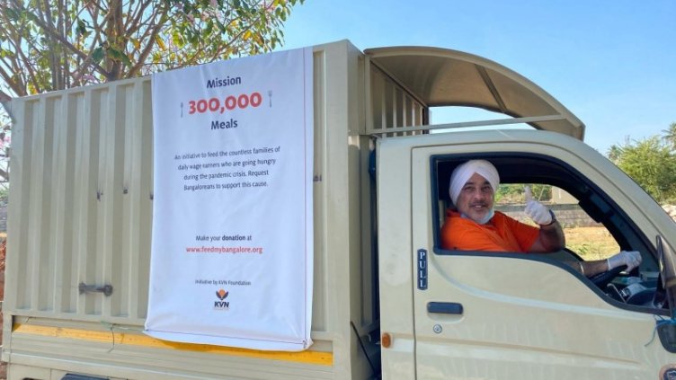 A male driving a 4 wheeler to feed meal to bangalore