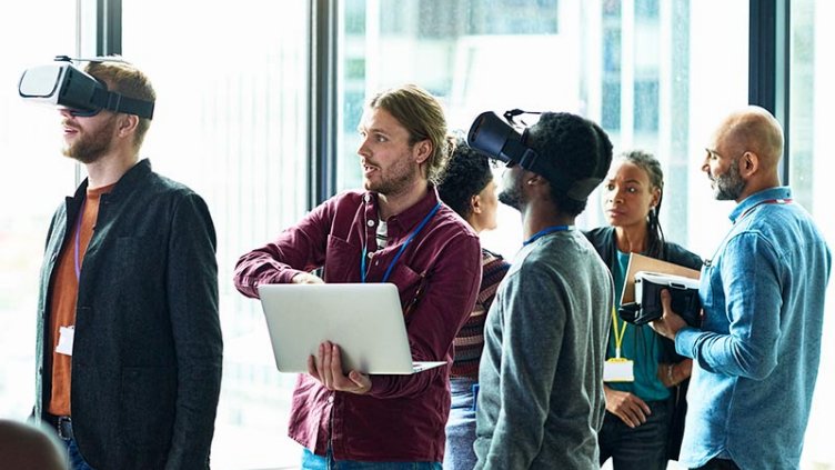 Female and male architects looking at a blueprint disussing business