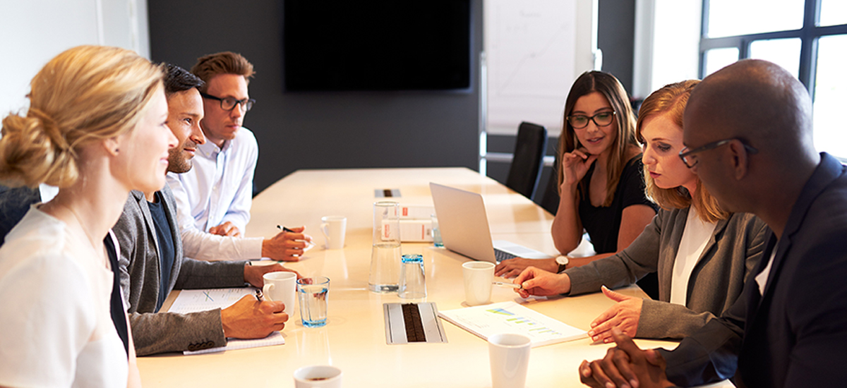 Group of young executives holding a work meeting in a conference room