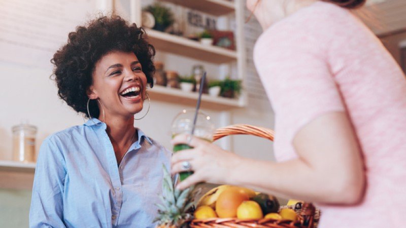 Two smiling women enjoying their free time at home