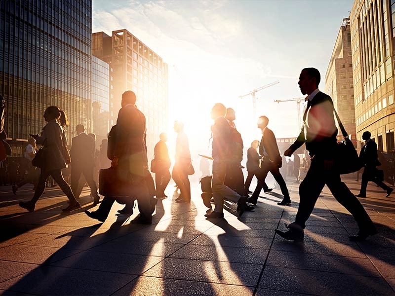 Commuters walking to work in the city at sunrise