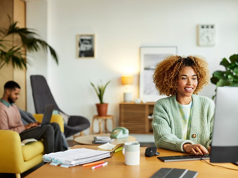 A woman working on her computer system inside the office