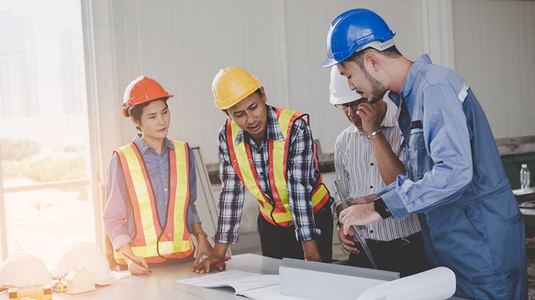 Engineers are meeting and pointing to new construction sites, Engineering tools and construction concept.