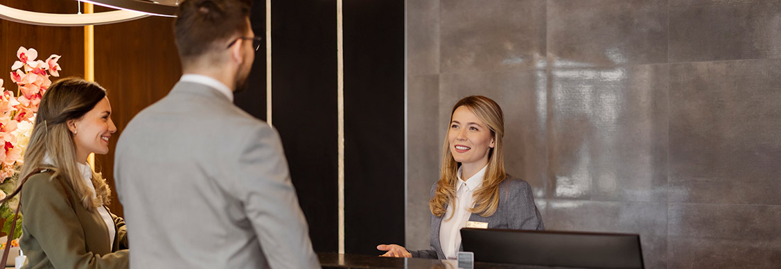 Couples talking with receptionist