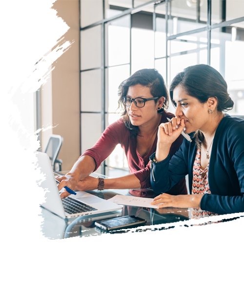 Two working professional ladies looking at the laptop