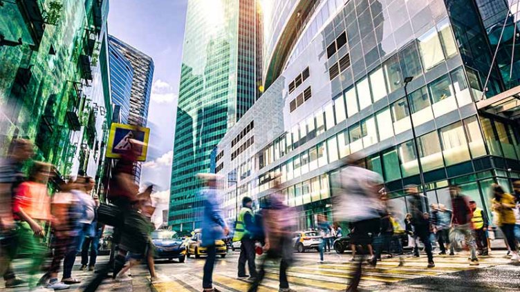 pedestrian crossing road in busy city