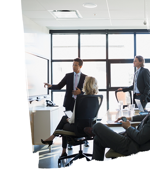 Employees having a meeting inside the meeting room in the real estate office