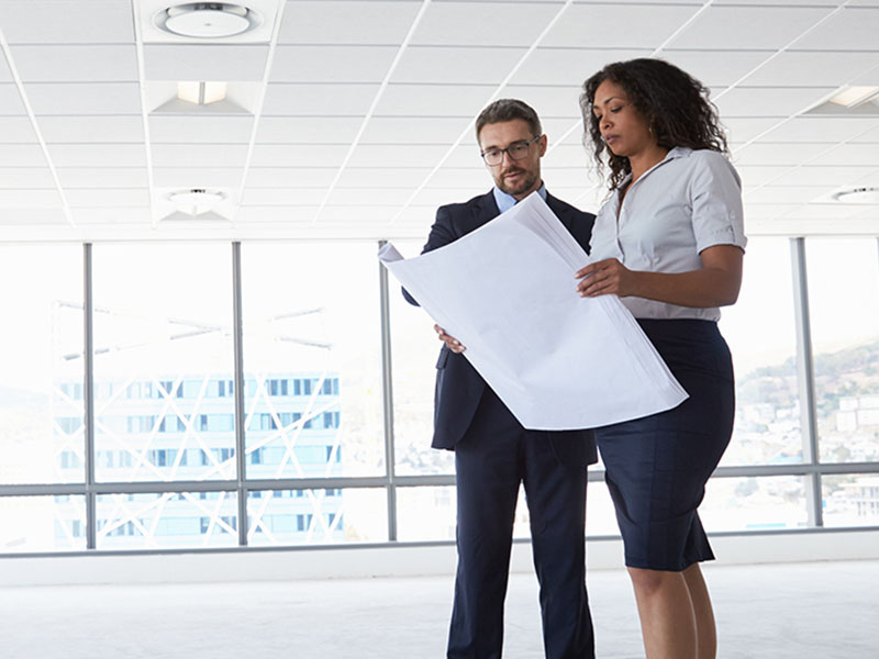 man and woman look over floorplan