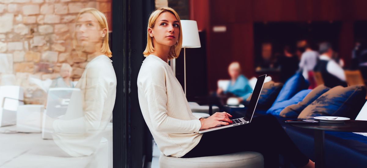 woman thinking while working at café