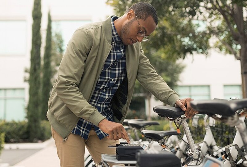 Businessman using a rideshare bicycle