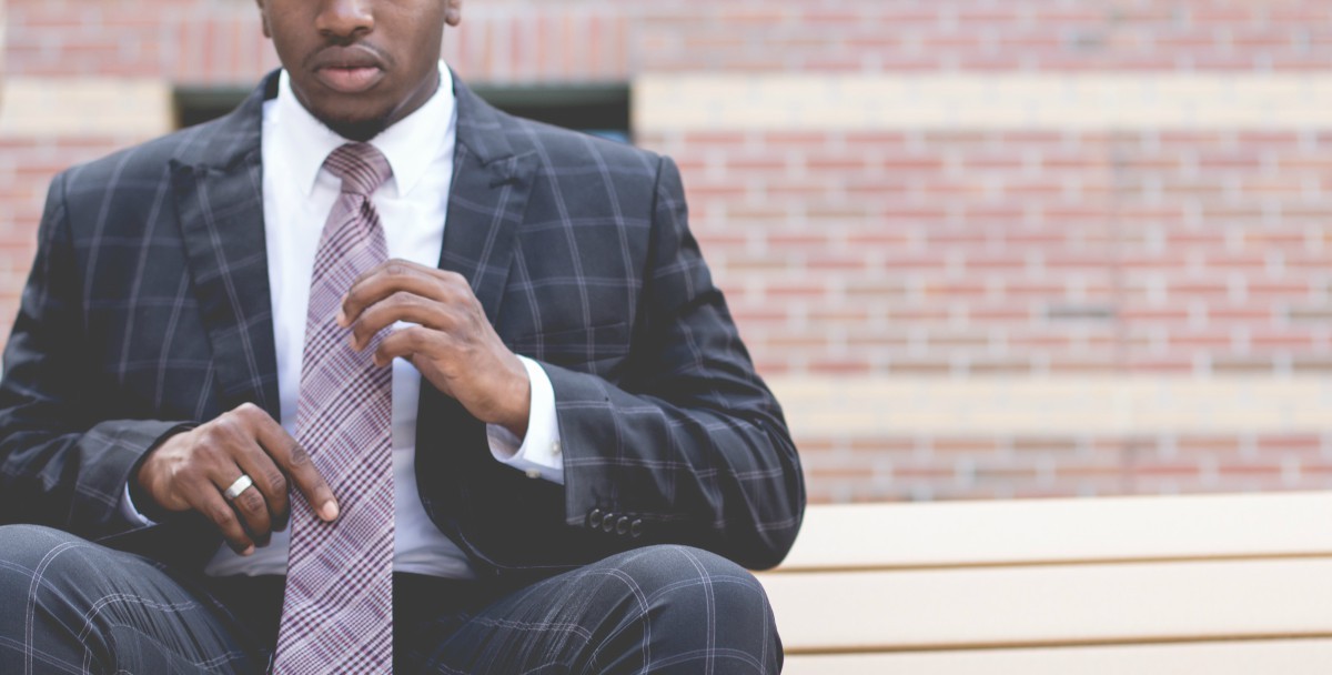 Main in Suit sitting on Stairs