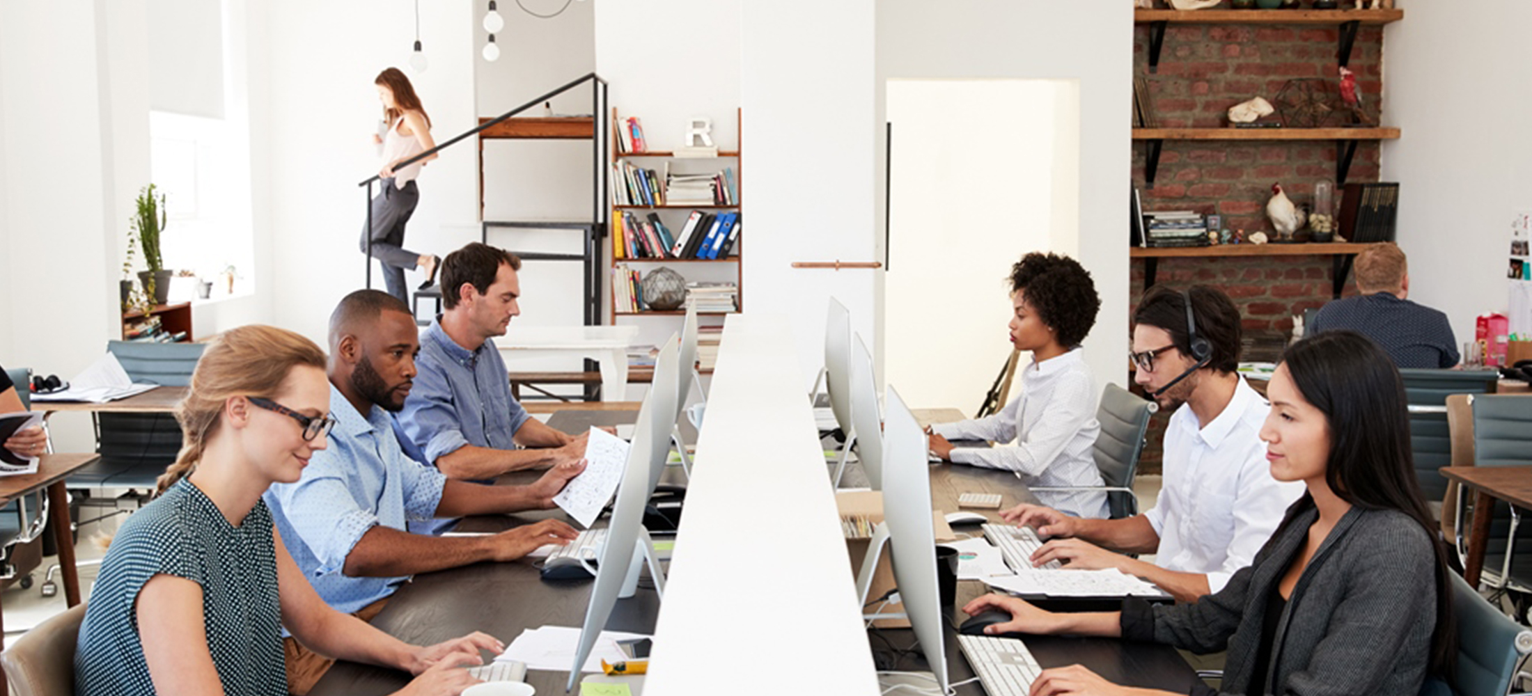 six employees in an open plan work space