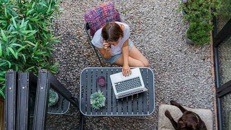 A lady working from home on laptop due to COVID-19