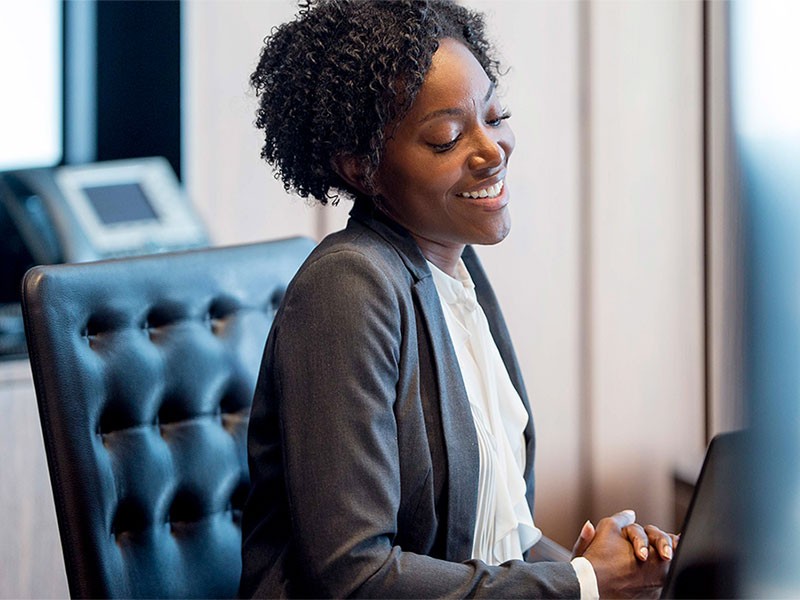 Woman having video call with her team members and smiling in the conversation