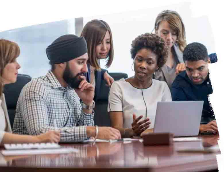 Group picture of JLL employees discussing something while looking at the laptop