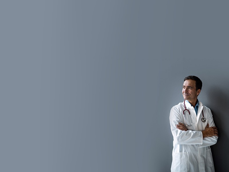 Smiling doctor looking at camera in the hospital